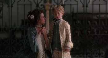 Movie still from “Frankenstein” (1994), directed by Kenneth Branagh – A woman and a boy dressed in period clothing; Medium shot, Over the shoulder angle