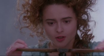 Movie still from “Frankenstein” (1994), directed by Kenneth Branagh – A person with curly red hair; Close Up shot, Overhead angle