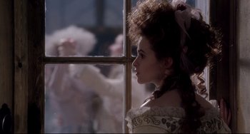 Movie still from “Frankenstein” (1994), directed by Kenneth Branagh – A young woman in a white dress looking out a window; Medium shot, Over the shoulder angle