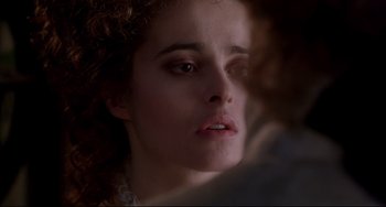 Movie still from “Frankenstein” (1994), directed by Kenneth Branagh – A woman's face in a dark room; Close Up shot, Over the shoulder angle