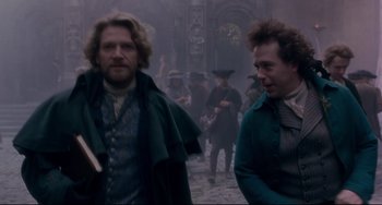 Movie still from “Frankenstein” (1994), directed by Kenneth Branagh – Two men walking on a street in front of a building; Medium shot, Low angle