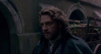 Movie still from “Frankenstein” (1994), directed by Kenneth Branagh – A person with long curly hair; Close Up shot, Over the shoulder angle