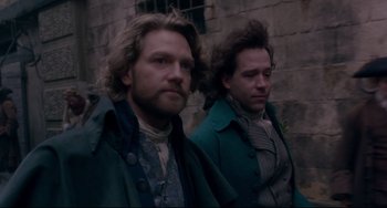 Movie still from “Frankenstein” (1994), directed by Kenneth Branagh – A couple of men standing next to each other; Medium shot, Low angle