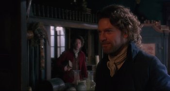 Movie still from “Frankenstein” (1994), directed by Kenneth Branagh – A man standing next to another man in a room; Medium shot, Over the shoulder angle