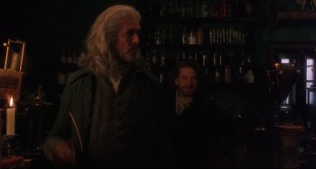 Movie still from “Frankenstein” (1994), directed by Kenneth Branagh – A man with long white hair standing next to another man with a beard; Medium shot, Over the shoulder angle