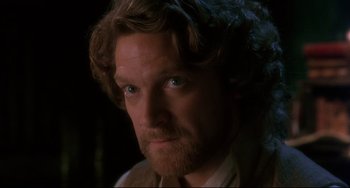 Movie still from “Frankenstein” (1994), directed by Kenneth Branagh – A person with a beard looking at the camera; Close Up shot, Over the shoulder angle