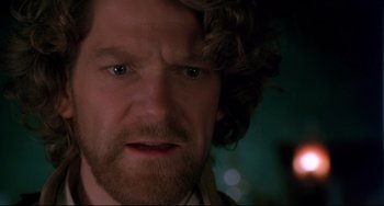 Movie still from “Frankenstein” (1994), directed by Kenneth Branagh – A person with curly hair and a beard; Close Up shot, Over the shoulder angle