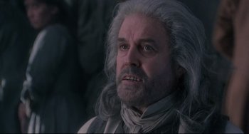 Movie still from “Frankenstein” (1994), directed by Kenneth Branagh – An old man with white hair is looking at the camera; Close Up shot, Low angle