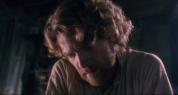 Movie still from “Frankenstein” (1994), directed by Kenneth Branagh – A person with long curly hair; Close Up shot, Low angle