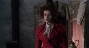 Movie still from “Frankenstein” (1994), directed by Kenneth Branagh – A woman in a red coat standing in front of a mirror; Medium shot, Over the shoulder angle