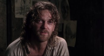 Movie still from “Frankenstein” (1994), directed by Kenneth Branagh – A person with long hair and a beard; Close Up shot, Over the shoulder angle