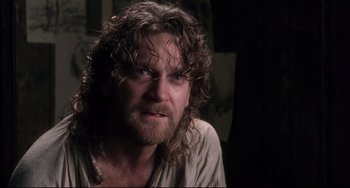 Movie still from “Frankenstein” (1994), directed by Kenneth Branagh – A person with long hair and a beard; Close Up shot, Over the shoulder angle