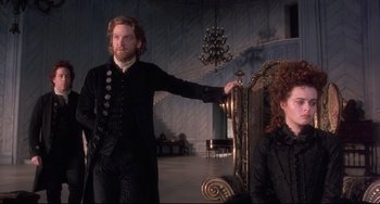 Movie still from “Frankenstein” (1994), directed by Kenneth Branagh – A man and a woman dressed in medieval garb in front of a throne; Medium shot, Low angle