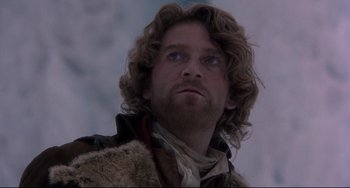 Movie still from “Frankenstein” (1994), directed by Kenneth Branagh – A person with long curly hair; Close Up shot, Low angle