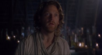 Movie still from “Frankenstein” (1994), directed by Kenneth Branagh – A person with long curly hair; Close Up shot, Low angle