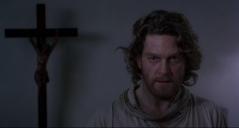 Movie still from “Frankenstein” (1994), directed by Kenneth Branagh – A person with long curly hair; Close Up shot, Over the shoulder angle
