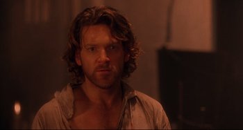 Movie still from “Frankenstein” (1994), directed by Kenneth Branagh – A person with long curly hair; Close Up shot, Over the shoulder angle