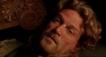 Movie still from “Frankenstein” (1994), directed by Kenneth Branagh – A person with long hair and a beard; Close Up shot, Overhead angle