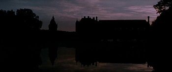 Movie still from “Mary, Queen of Scots” (1971), directed by Charles Jarrott – A dark picture of a castle and a body of water at night; Extreme Wide shot, Low angle