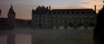 Movie still from “Mary, Queen of Scots” (1971), directed by Charles Jarrott – A castle with a lake in front of it; Extreme Wide shot, High angle