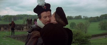 Movie still from “Mary, Queen of Scots” (1971), directed by Charles Jarrott – A man and a woman kissing each other in front of a field; Close Up shot, Over the shoulder angle