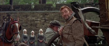 Movie still from “Mary, Queen of Scots” (1971), directed by Charles Jarrott – A group of people standing next to each other in a field; Medium shot, Over the shoulder angle