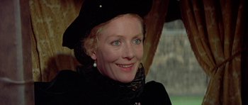 Movie still from “Mary, Queen of Scots” (1971), directed by Charles Jarrott – An older woman wearing a black hat and a black coat; Close Up shot, Over the shoulder angle