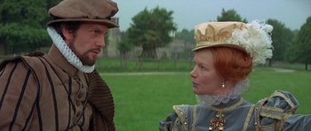 Movie still from “Mary, Queen of Scots” (1971), directed by Charles Jarrott – A man and a woman standing next to each other in a field; Close Up shot, Over the shoulder angle