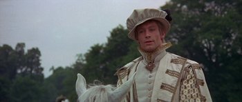 Movie still from “Mary, Queen of Scots” (1971), directed by Charles Jarrott – A man in a white outfit holding a white horse; Close Up shot, Over the shoulder angle