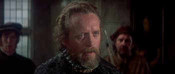 Movie still from “Mary, Queen of Scots” (1971), directed by Charles Jarrott – An older man with a beard and a mustache; Close Up shot, Over the shoulder angle