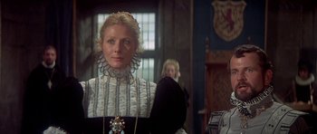 Movie still from “Mary, Queen of Scots” (1971), directed by Charles Jarrott – A woman in a black and white dress standing in front of another woman in a black dress; Close Up shot, Low angle