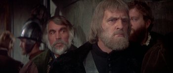 Movie still from “Mary, Queen of Scots” (1971), directed by Charles Jarrott – Two men with long hair and beards are looking into the distance; Close Up shot, Over the shoulder angle