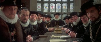 Movie still from “Mary, Queen of Scots” (1971), directed by Charles Jarrott – A group of men sitting around a table; Medium shot, Over the shoulder angle