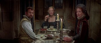 Movie still from “Mary, Queen of Scots” (1971), directed by Charles Jarrott – A group of people sitting around a table with food; Medium shot, High angle