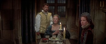Movie still from “Mary, Queen of Scots” (1971), directed by Charles Jarrott – A man and a woman sitting at a table with candles; Medium shot, High angle