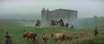 Movie still from “Mary, Queen of Scots” (1971), directed by Charles Jarrott – A group of people on horses and cattle in a field; Extreme Wide shot, Low angle