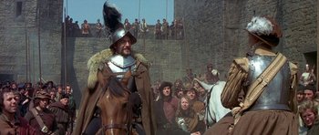 Movie still from “Mary, Queen of Scots” (1971), directed by Charles Jarrott – A crowd of people watching a man on a horse; Medium shot, Over the shoulder angle