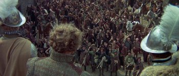 Movie still from “Mary, Queen of Scots” (1971), directed by Charles Jarrott – A crowd of people standing in the middle of a street; Extreme Wide shot, High angle