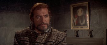 Movie still from “Mary, Queen of Scots” (1971), directed by Charles Jarrott – A person wearing a suit and tie; Close Up shot, Over the shoulder angle