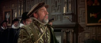 Movie still from “Mary, Queen of Scots” (1971), directed by Charles Jarrott – A man wearing a hat and a green outfit; Close Up shot, Over the shoulder angle