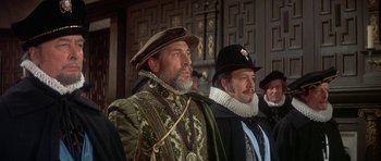 Movie still from “Mary, Queen of Scots” (1971), directed by Charles Jarrott – A group of men standing next to each other; Medium shot, Low angle