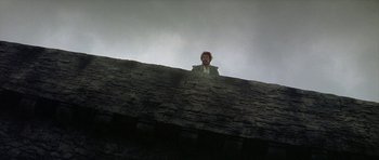 Movie still from “Mary, Queen of Scots” (1971), directed by Charles Jarrott – A man standing on top of a stone wall; Wide shot, Low angle