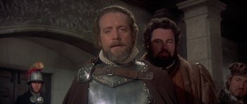 Movie still from “Mary, Queen of Scots” (1971), directed by Charles Jarrott – A man in a chain mail armor and a man with a beard; Close Up shot, Low angle