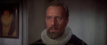 Movie still from “Mary, Queen of Scots” (1971), directed by Charles Jarrott – A man with a beard wearing a black and white outfit; Close Up shot, Low angle