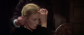 Movie still from “Mary, Queen of Scots” (1971), directed by Charles Jarrott – A woman in a black shirt is holding her hand up to her face; Close Up shot, High angle