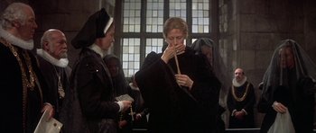 Movie still from “Mary, Queen of Scots” (1971), directed by Charles Jarrott – A woman in a black robe is holding a cane; Medium shot, High angle