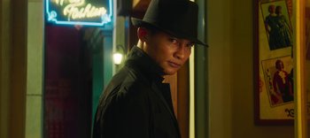 Movie still from “Master Z: The Ip Man Legacy” (2018), directed by Woo-Ping Yuen – A man wearing a black hat and a black jacket; Close Up shot, Low angle