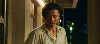 Movie still from “Master Z: The Ip Man Legacy” (2018), directed by Woo-Ping Yuen – A person wearing a white shirt; Close Up shot, Low angle