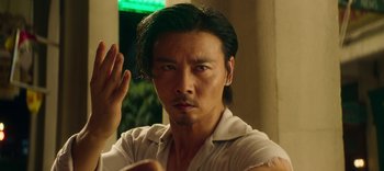 Movie still from “Master Z: The Ip Man Legacy” (2018), directed by Woo-Ping Yuen – A person wearing a white shirt; Close Up shot, Low angle