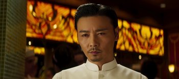 Movie still from “Master Z: The Ip Man Legacy” (2018), directed by Woo-Ping Yuen – A person wearing a white shirt; Close Up shot, Low angle